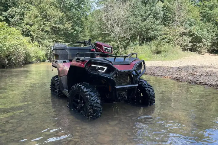 a truck is parked on the side of a river